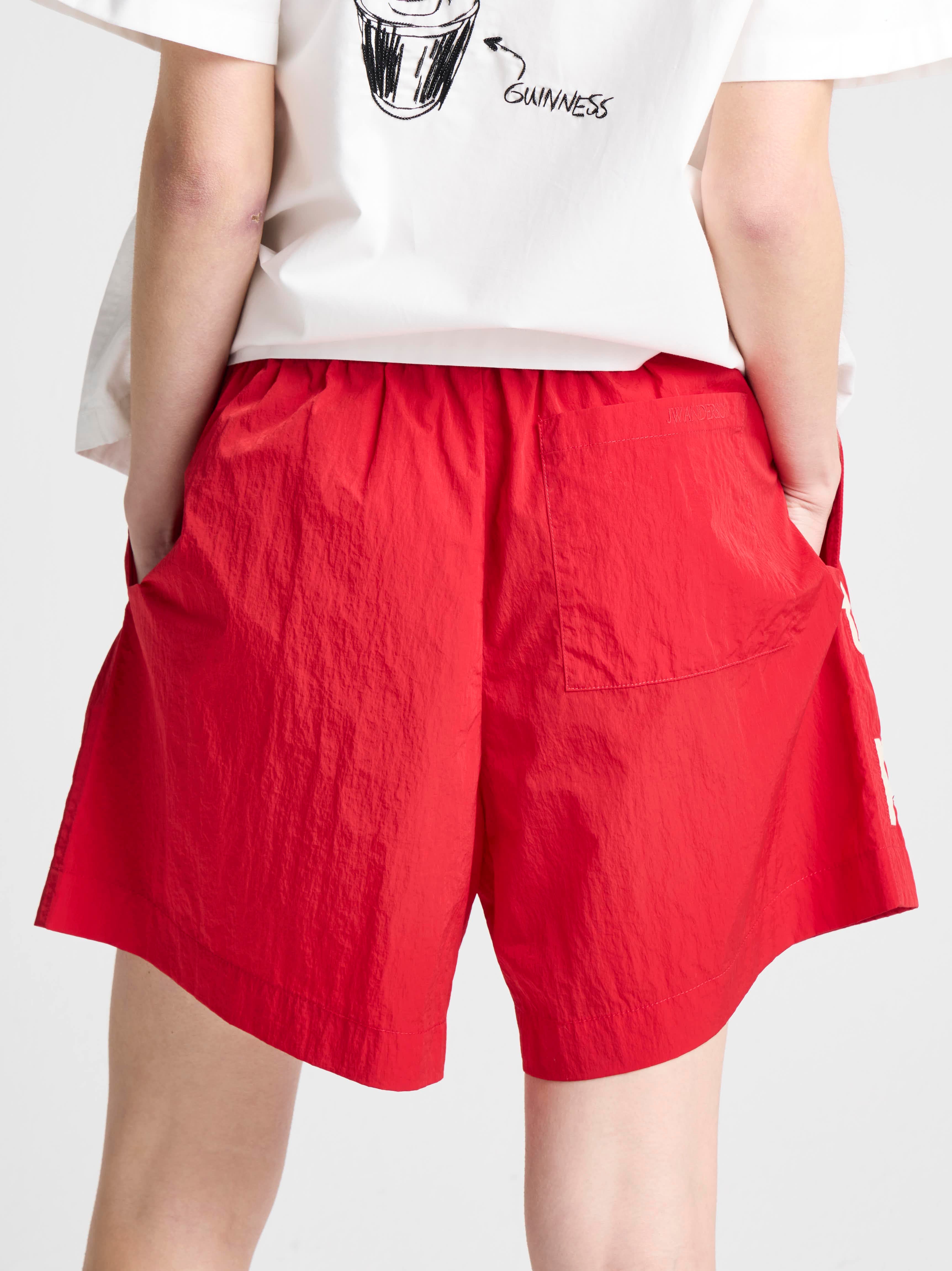 JW Anderson x Guinness Track Shorts Rot Unisex